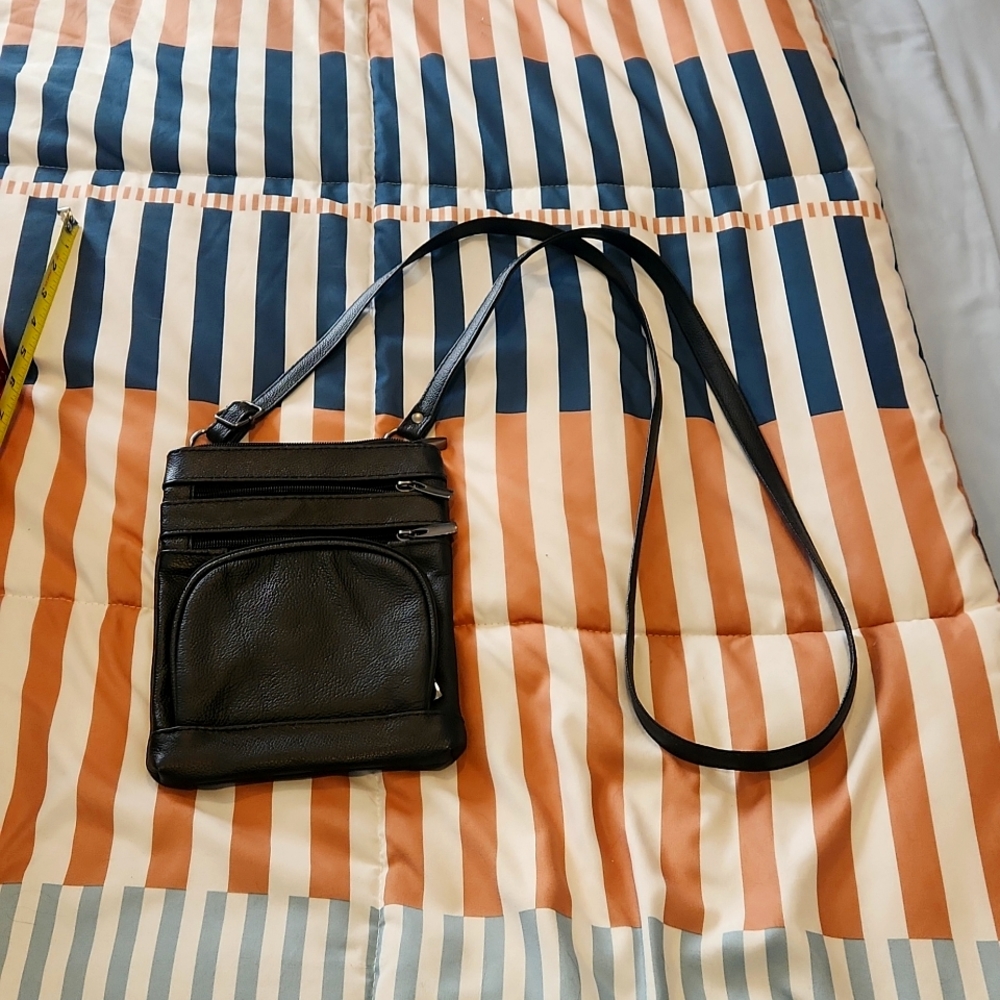 Black leather like small crossbody bag great for traveling.